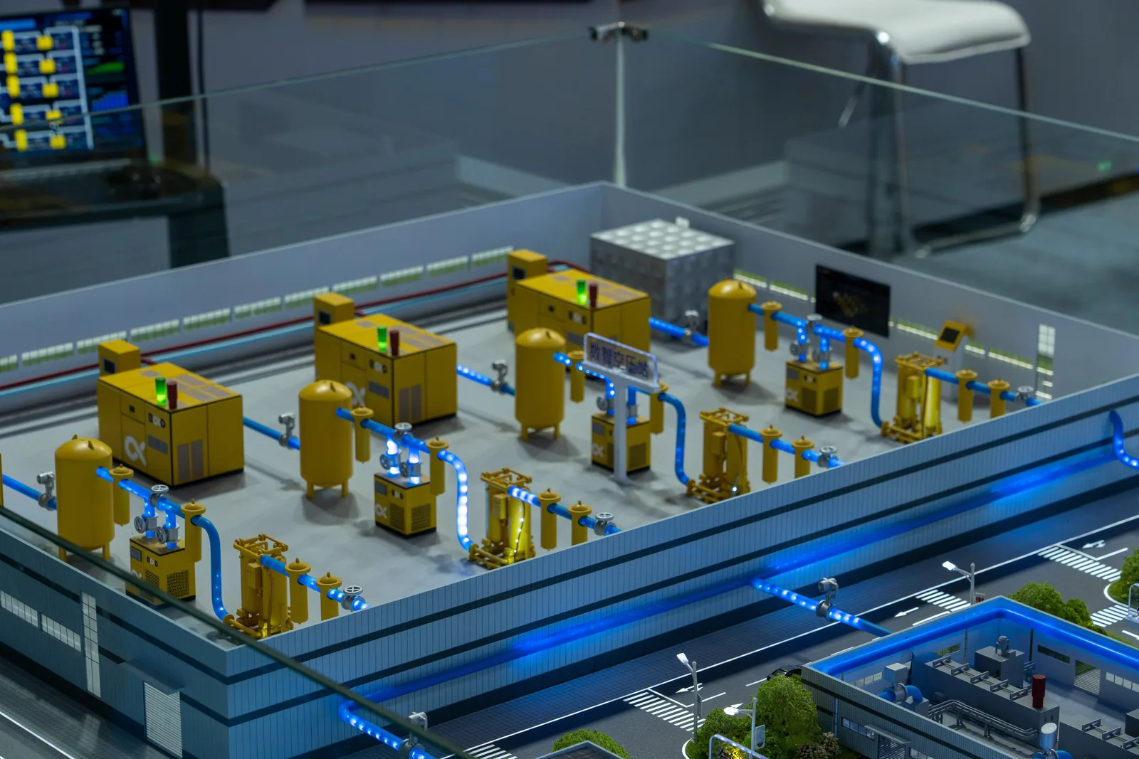Detailed industrial model display showcasing machinery and systems indoors, emphasizing technology and design.